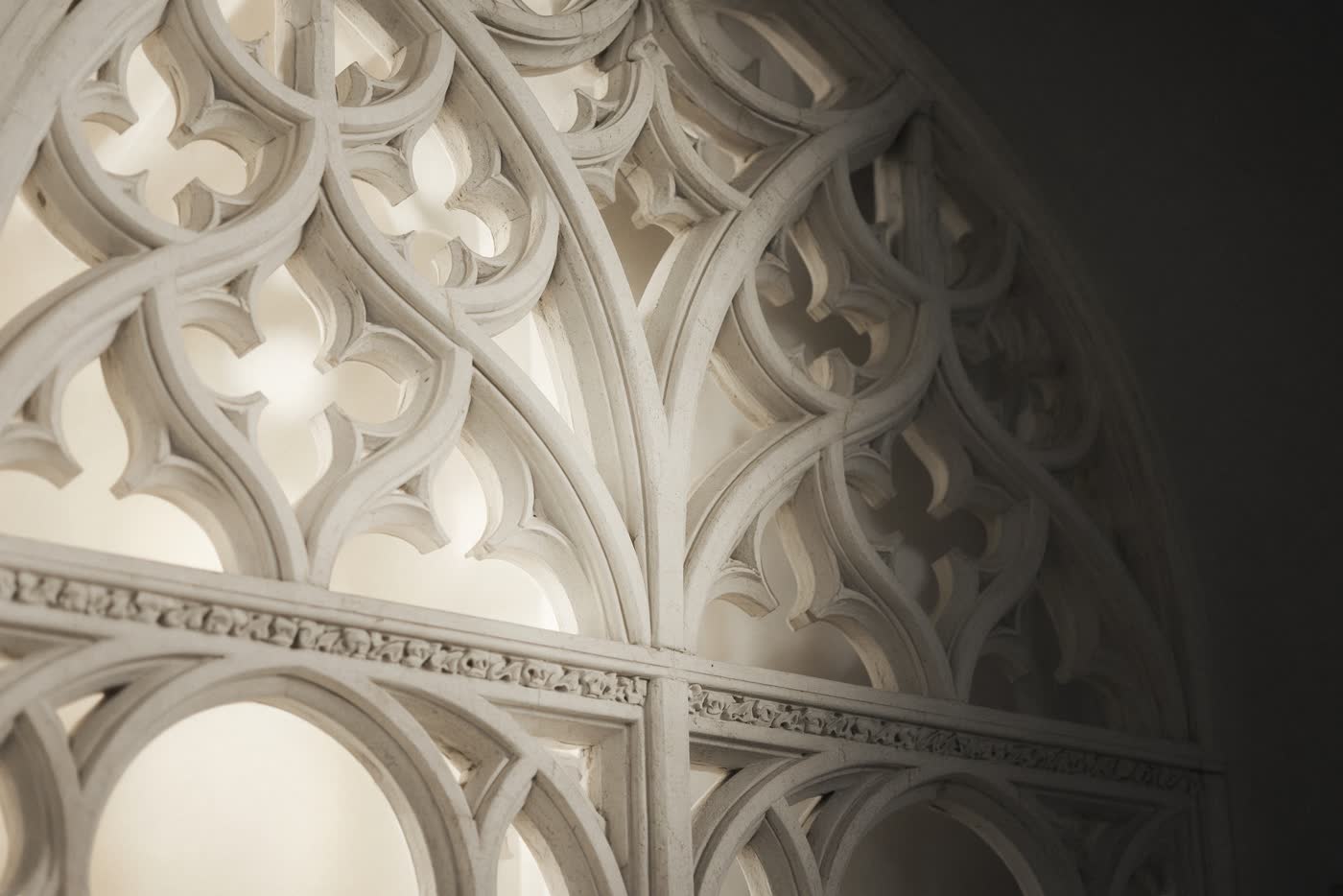 Close view of pale stone tracery, pointed arches interlocking. Architectural photograph, not a client wedding.